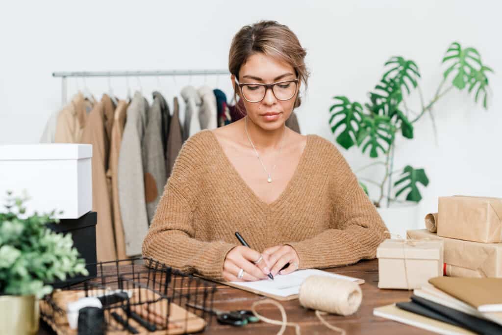 Female business owner reviewing inventory counts for excess stock