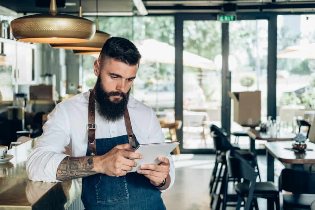 Barista looking at ingredients set to expire soon