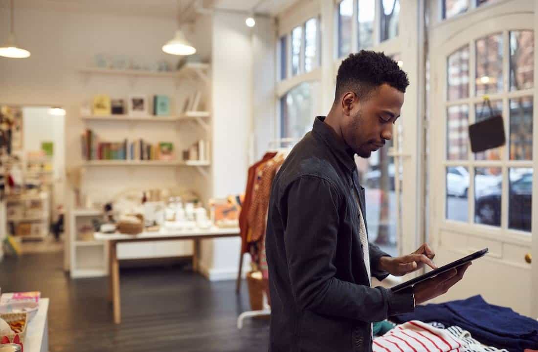Store employee selecting soundtrack